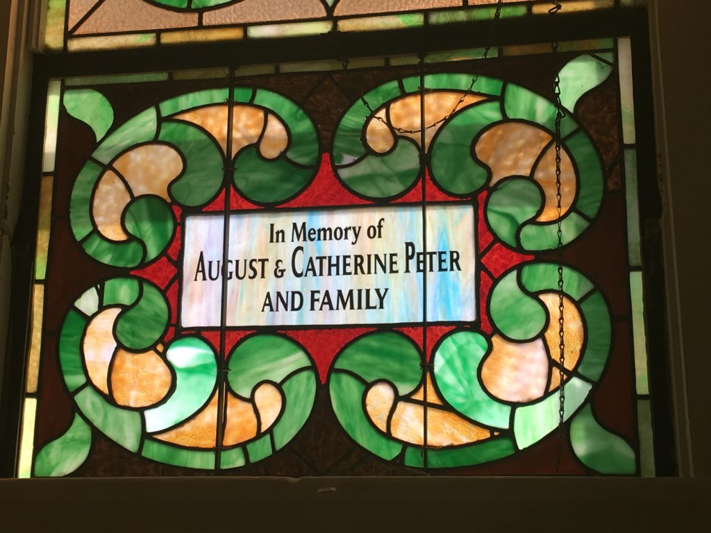 new namplate installed in restored stained glass window